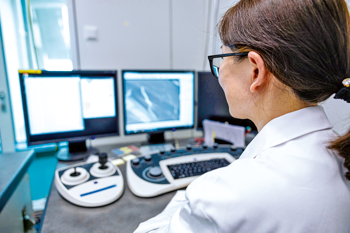 Research associate Congyu Wu performs scanning electron microscopy to characterise nanomolecules designed to bind to the blood-brain barrier.